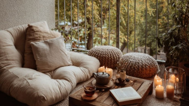 A single meditation cushion and mat arranged in soft natural light, symbolizing quiet support, care, and the spacious simplicity of retreat practice.