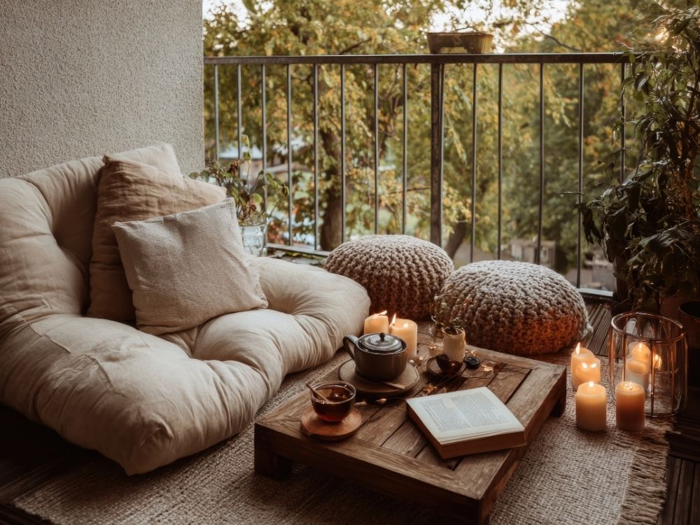A single meditation cushion and mat arranged in soft natural light, symbolizing quiet support, care, and the spacious simplicity of retreat practice.