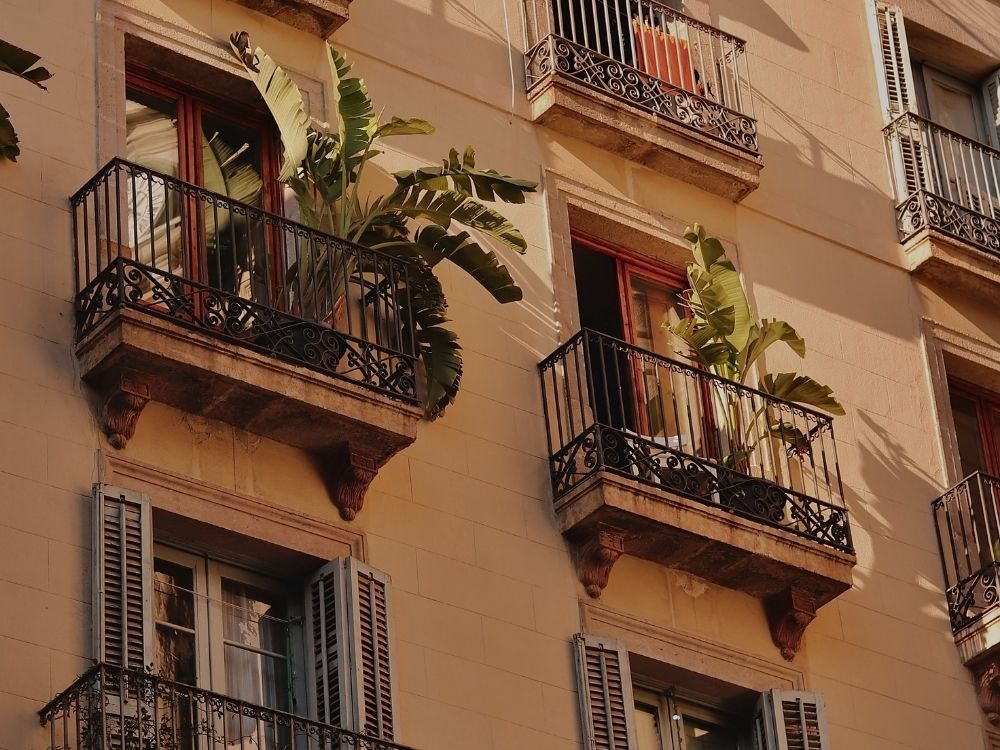Rows of balconies with plants and light, symbolizing connection during separation
