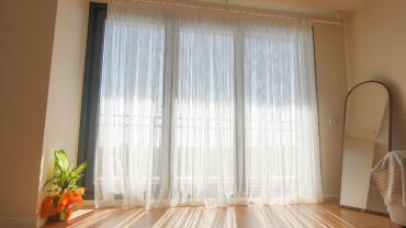 window, slightly ajar, with soft warm light coming through the gap.
