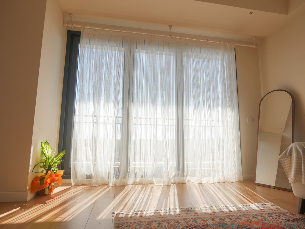 window, slightly ajar, with soft warm light coming through the gap.