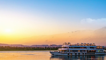 Cruise ship at sunset on the sea, symbolizing comfort, shelter, and search for Dharma
