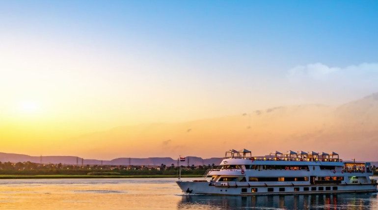 Cruise ship at sunset on the sea, symbolizing comfort, shelter, and search for Dharma