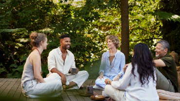 A small group sitting together in a quiet circle, reflecting shared presence and community.