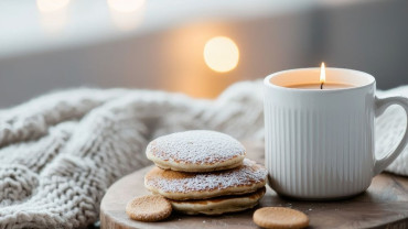 A softly lit room during wintertime with a feeling of quiet warmth indoors.