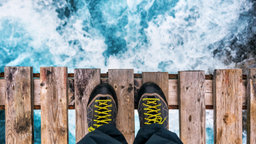 person's feet at the edge of a threshold