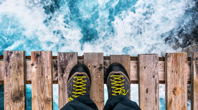 person's feet at the edge of a threshold
